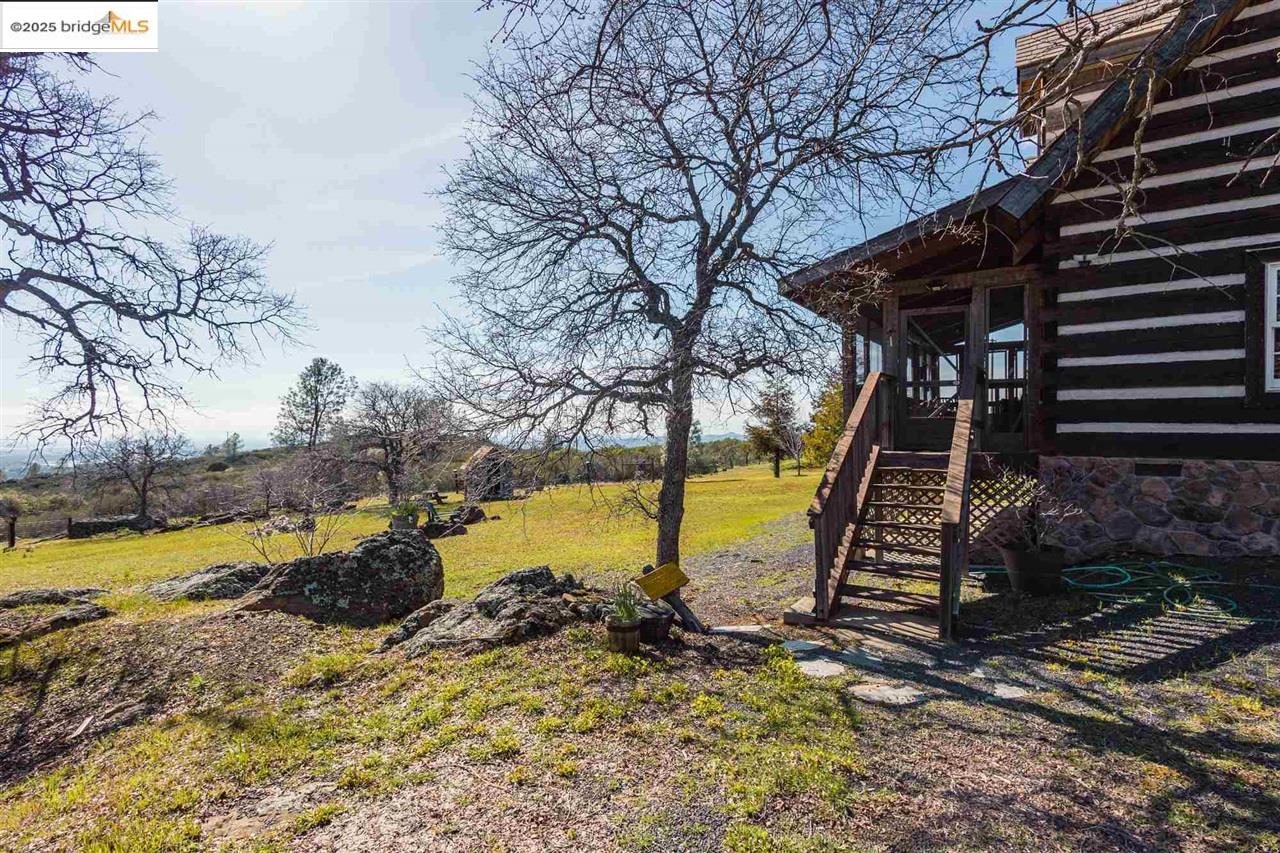 16101 Moccasin Ranch Road Coulterville, CA 95311 - Photo 59 of 60 a view of a yard with swimming pool and wooden fence