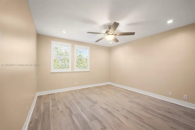 a bedroom with bed and a potted plant