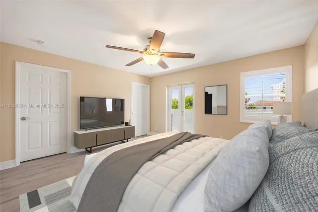 a bathroom with a granite countertop sink a toilet a mirror and shower