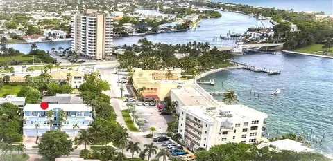 a view of a multi story building with a palm tree