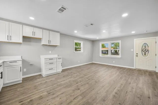 a view of kitchen with wooden floor electronic appliances and window