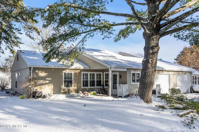 a front view of a house with glass windows and outdoor space