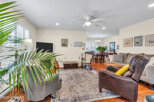 a living room with furniture a ceiling fan and a rug