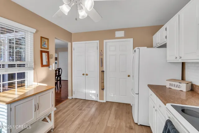 a view of kitchen with stainless steel appliances granite countertop a refrigerator and a stove top oven