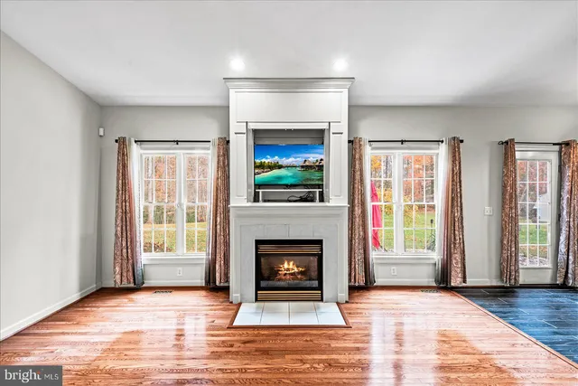 a kitchen with stainless steel appliances a sink and wooden floor