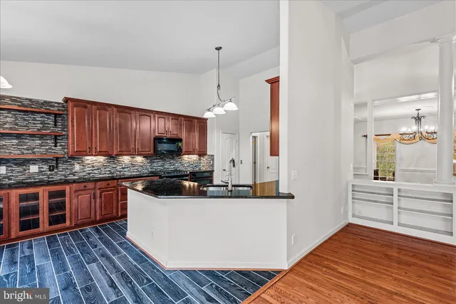 a view of wooden floor and windows in a room