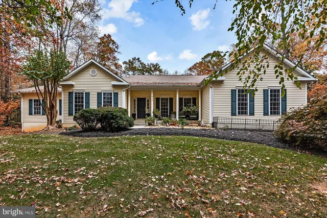 a front view of a house with a garden and yard