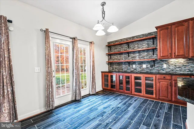 a kitchen with stainless steel appliances granite countertop a sink a refrigerator and a stove