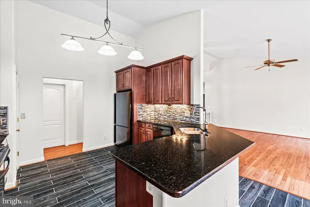 a kitchen with stainless steel appliances granite countertop a stove a sink dishwasher and a refrigerator