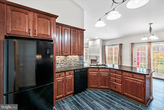 a kitchen with wooden cabinets stove top oven and sink