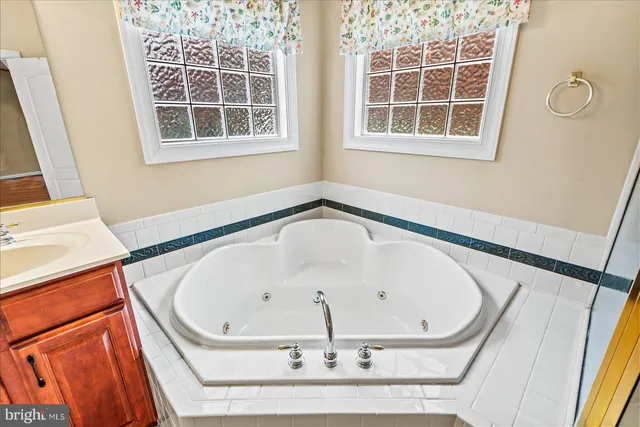 a view of an empty room with a window and fireplace