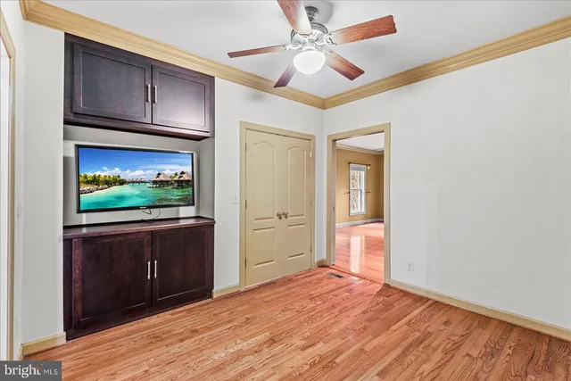 a view of an empty room with a window and fire place