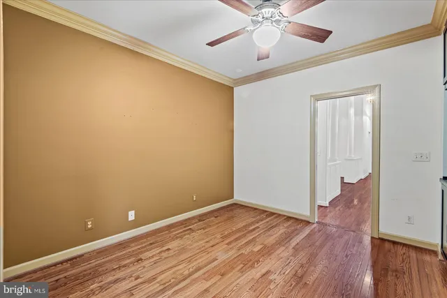 a view of an empty room with a fireplace and a window