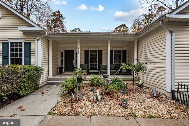 a view of a house with sitting area and garden