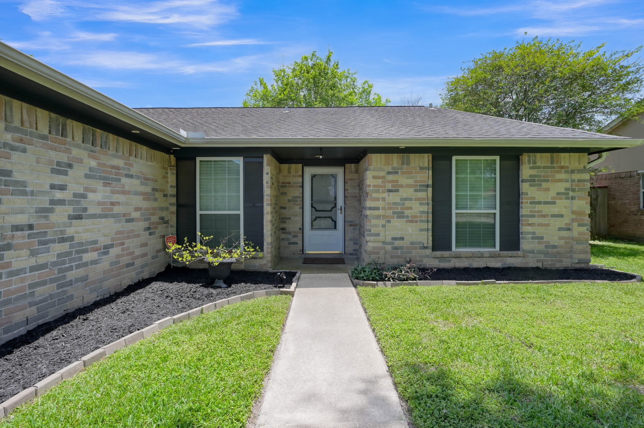 12015 Fallbrook Drive Houston, TX 77065 - Photo 3 of 29 This charming single-story home features a classic brick exterior with a welcoming front porch. It has a well-maintained lawn and neat landscaping, offering great curb appeal.
