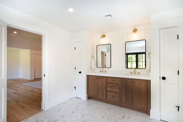 a view of a bathroom with dual sinks