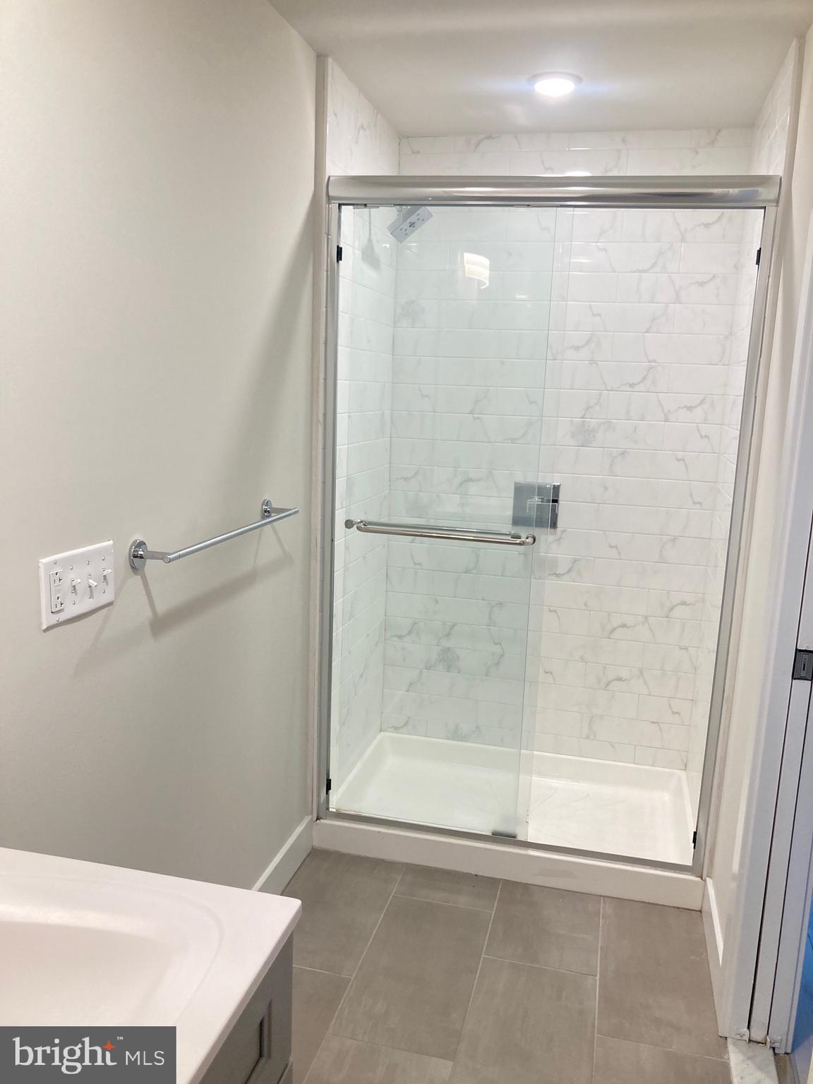 2551 North Front Street, Unit 3 Philadelphia, PA 19133 - Photo 11 of 16 a bathroom with a shower and a bath tub