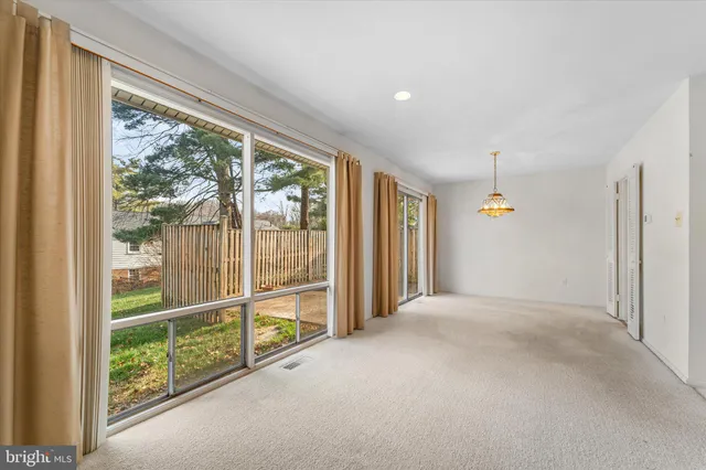 an empty room with sliding glass door and mountain view