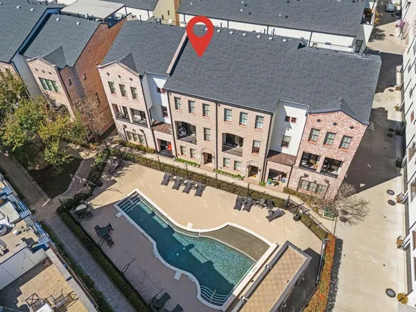 an aerial view of residential houses with outdoor space and street view