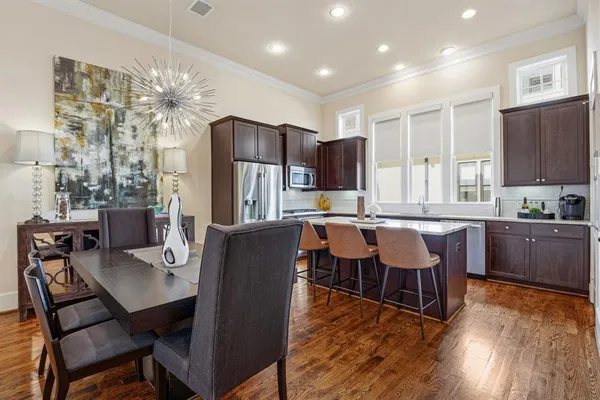 a view of a dining room with furniture window and wooden floor