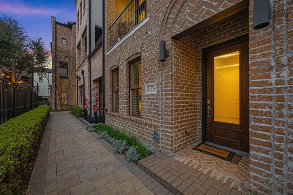a view of a pathway along the brick building