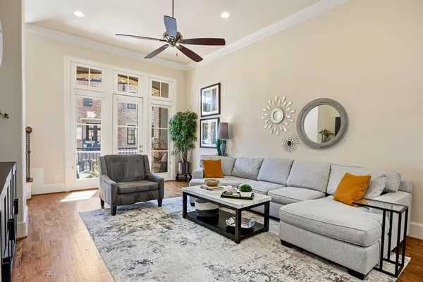a living room with furniture a flat screen tv and kitchen view