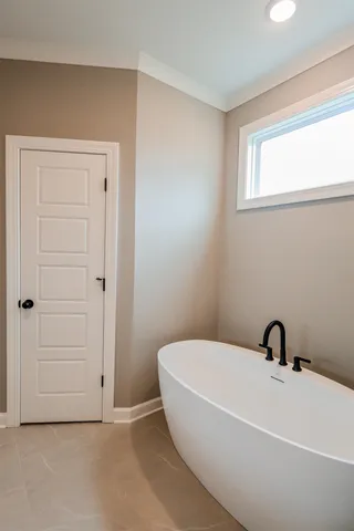 a bathroom with a white tub shower and sink