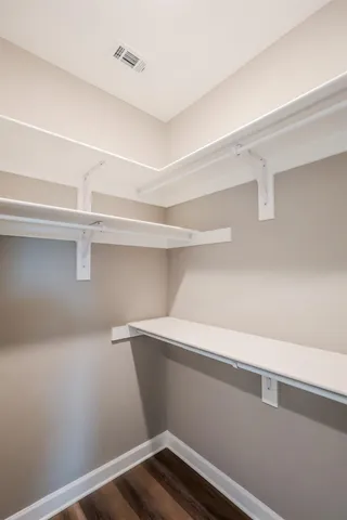 a spacious bathroom with a double vanity sink a mirror and a shower
