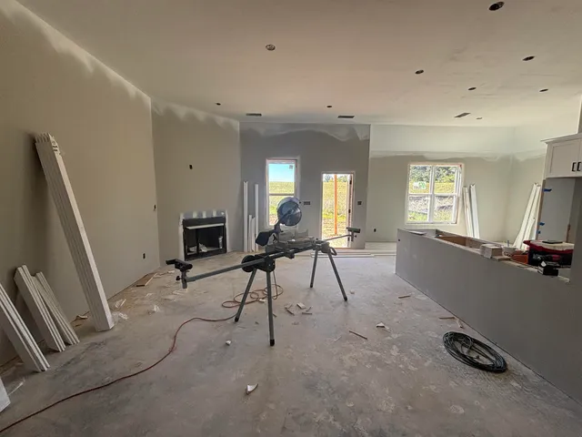 a living room with furniture a flat screen tv and a window