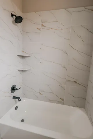 a bathroom with a granite countertop sink toilet and mirror