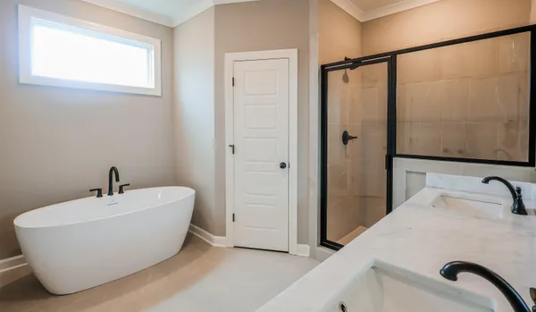 a spacious bathroom with a double vanity sink a mirror and a shower