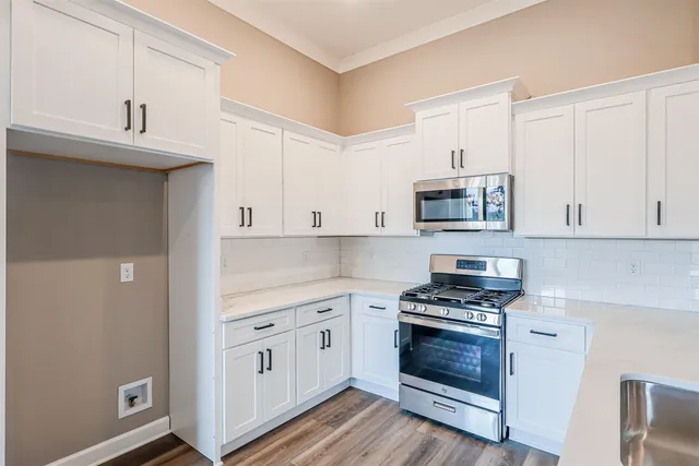 wooden floor fireplace and windows in an empty room
