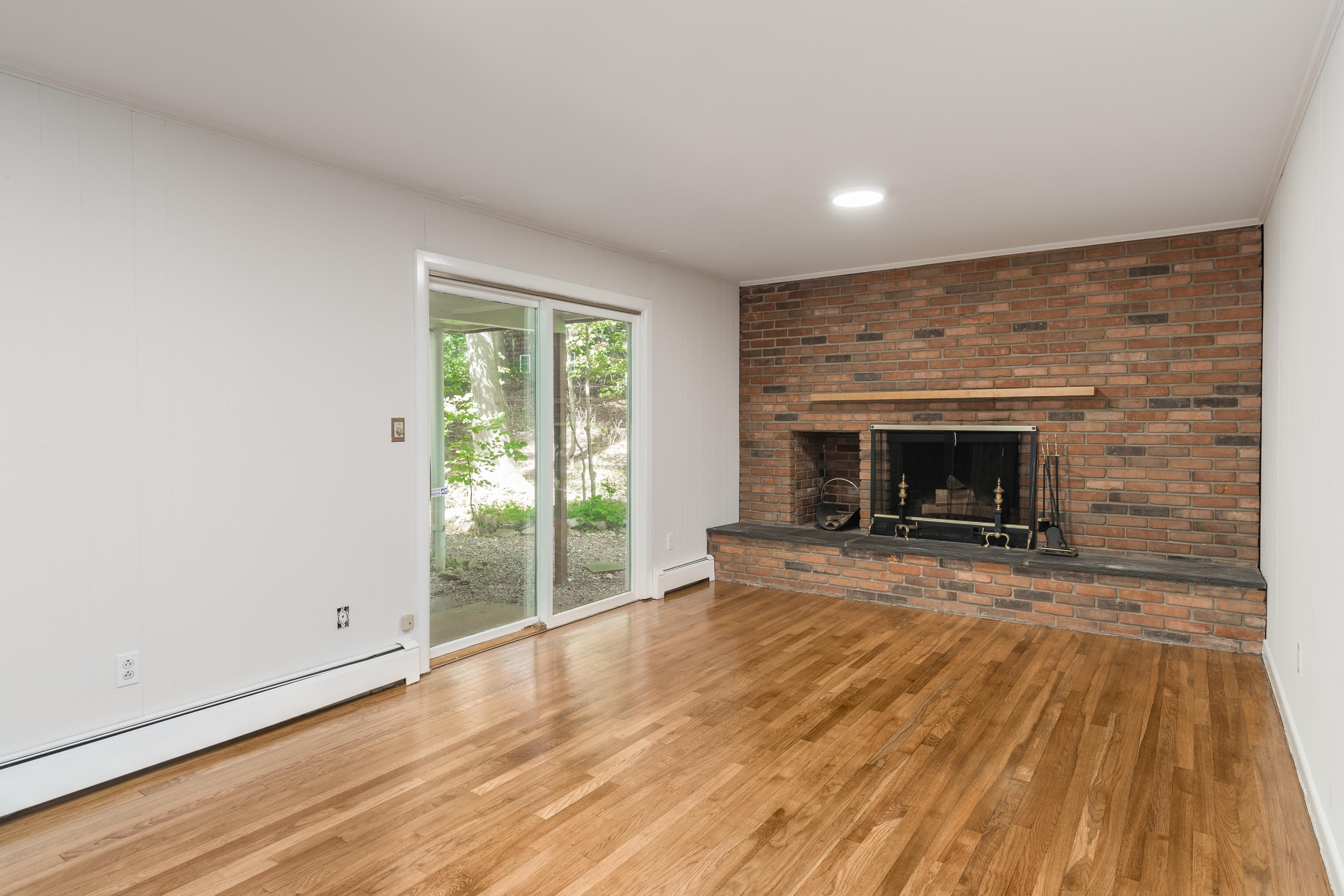 4 Littlebrook Road North Darien, CT 06820 - Photo 14 of 42 a view of an empty room with wooden floor fireplace and a window