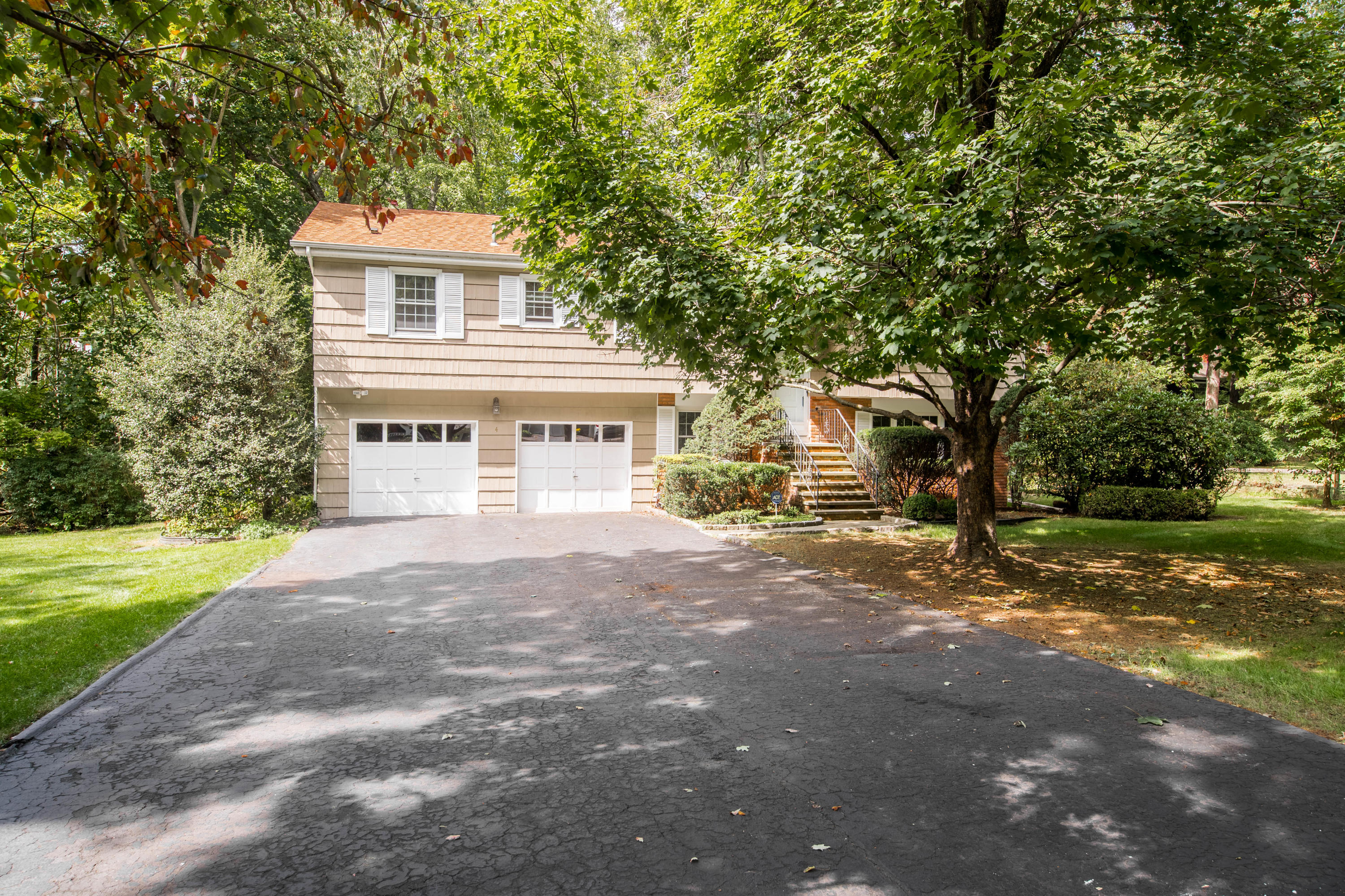 4 Littlebrook Road North Darien, CT 06820 - Photo 2 of 42 a front view of a house with a yard and garage