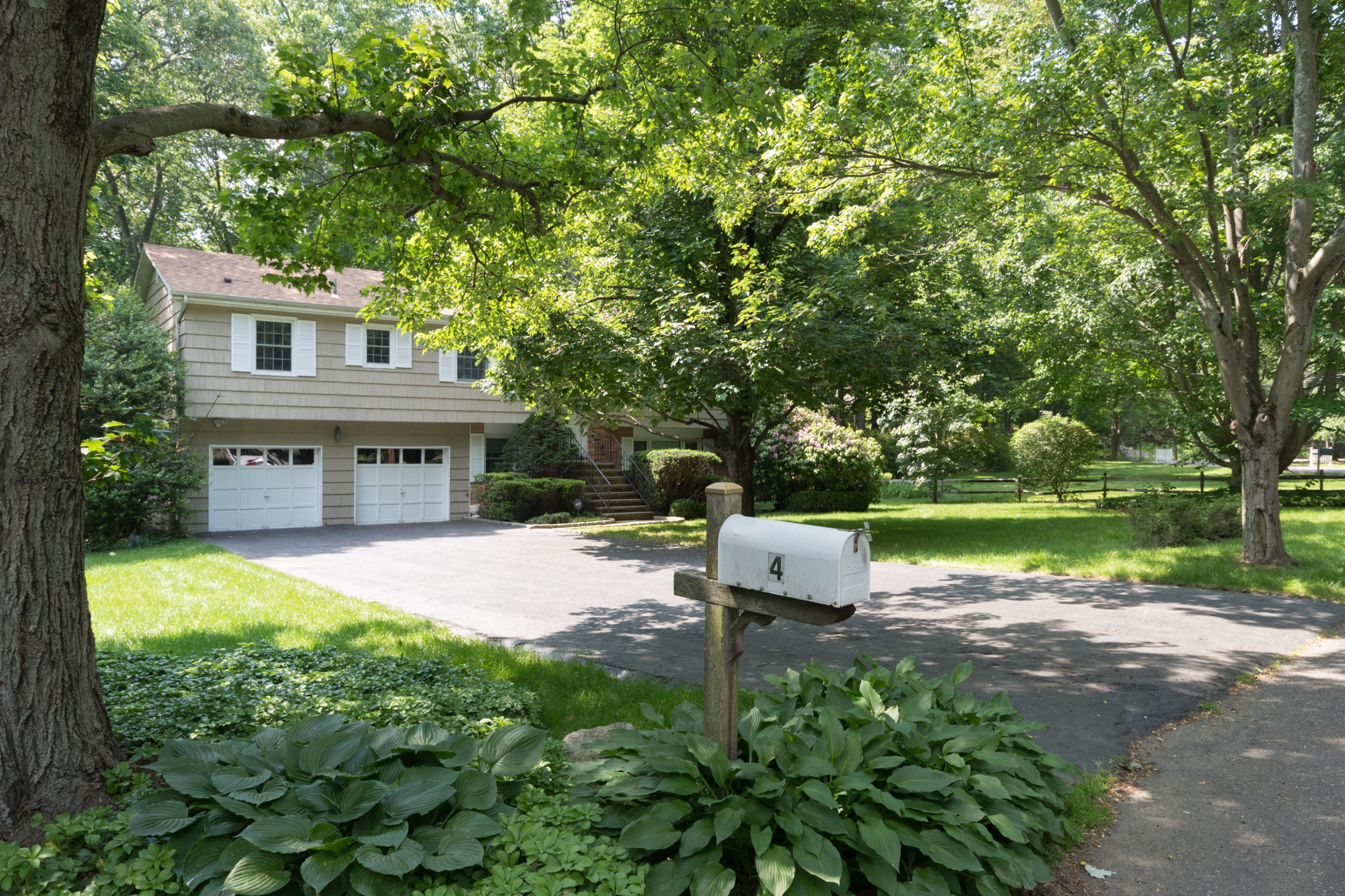 4 Littlebrook Road North Darien, CT 06820 - Photo 3 of 42 a front view of a house with garden