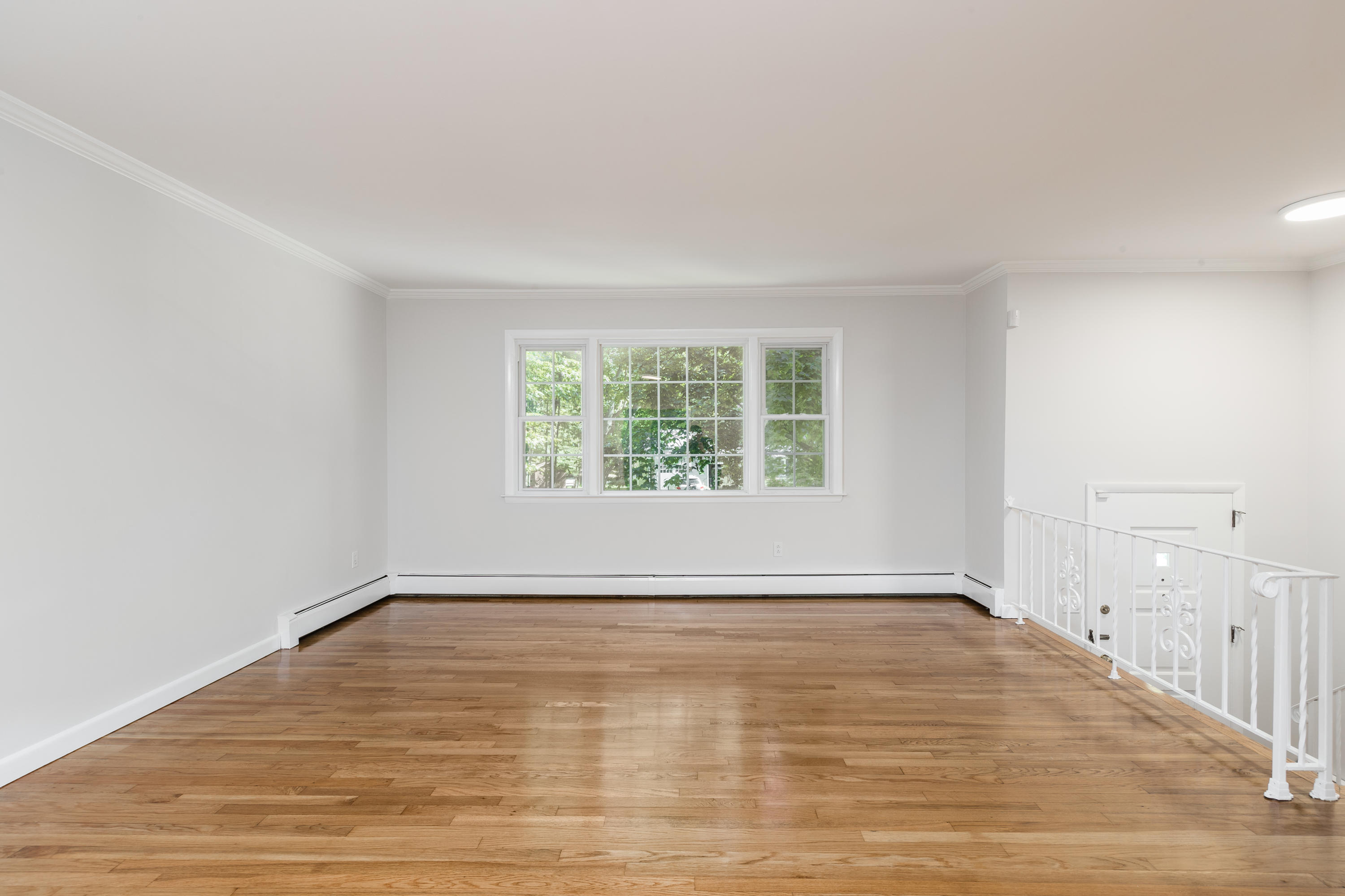 4 Littlebrook Road North Darien, CT 06820 - Photo 6 of 42 a view of an empty room with wooden floor and a window