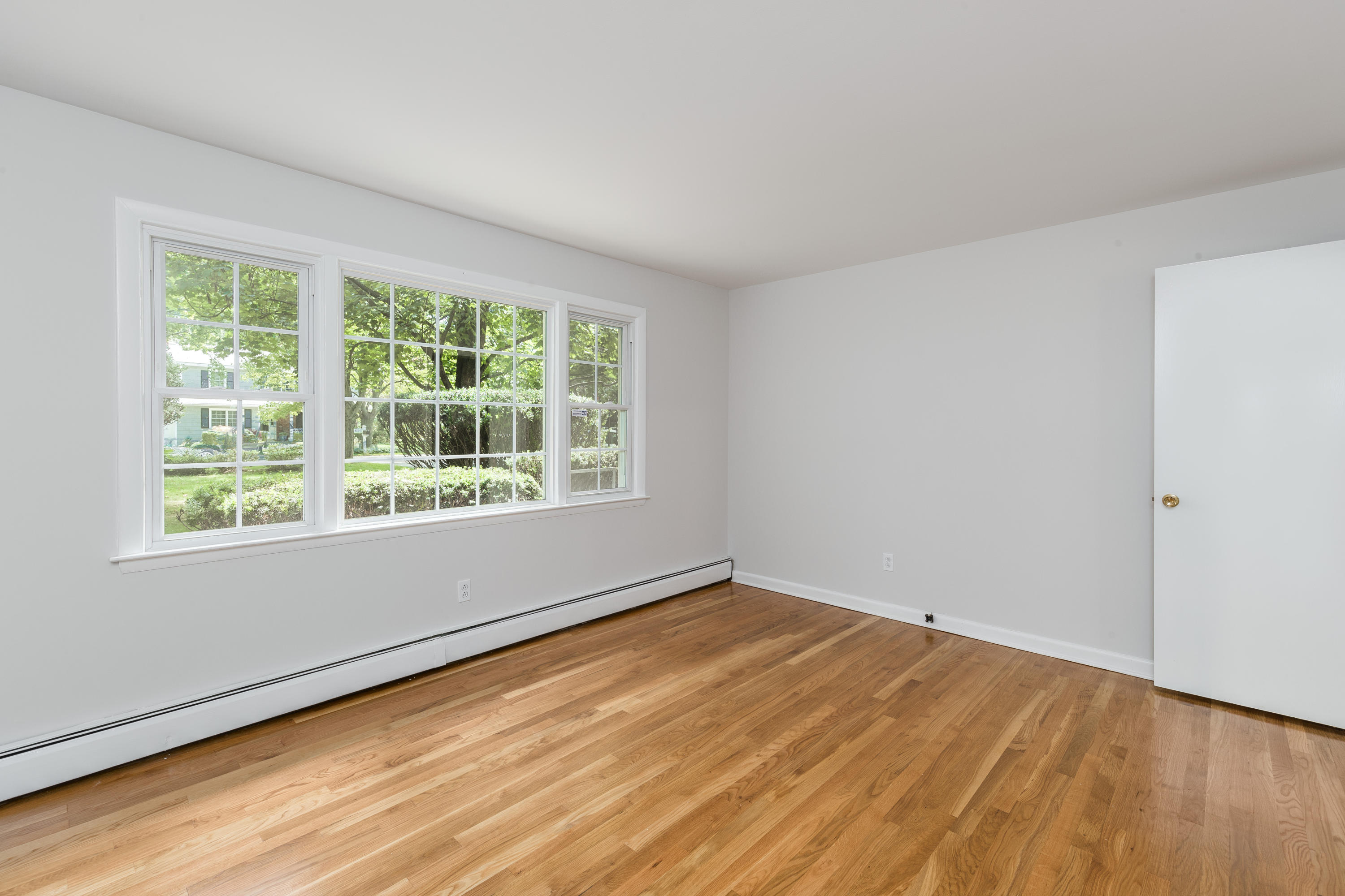4 Littlebrook Road North Darien, CT 06820 - Photo 10 of 42 a view of an empty room with wooden floor and a window