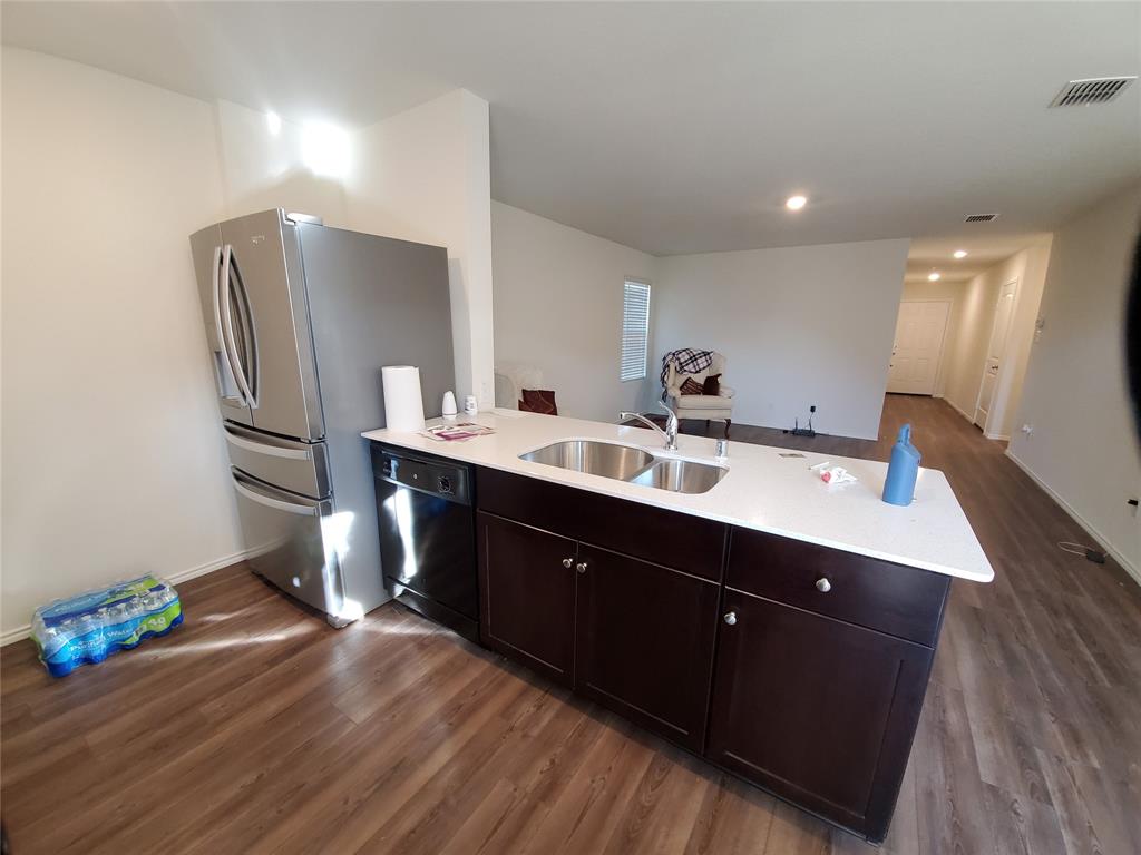 414 Sweetshade Lane Princeton, TX 75407 - Photo 3 of 10 a room with a sink wooden floor and a mirror