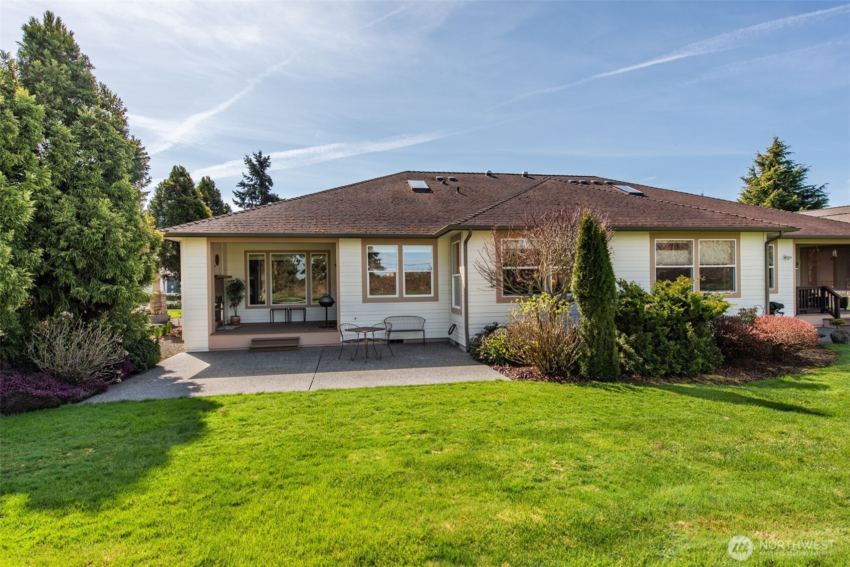 71 Mt Baker Drive Sequim, WA 98382 - Photo 21 of 25 a patio with a table and chairs under an umbrella