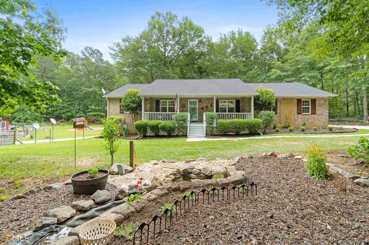 349 Christian Road Juliette, GA 31046 - Photo 1 of 1 a view of a house with backyard sitting area and garden