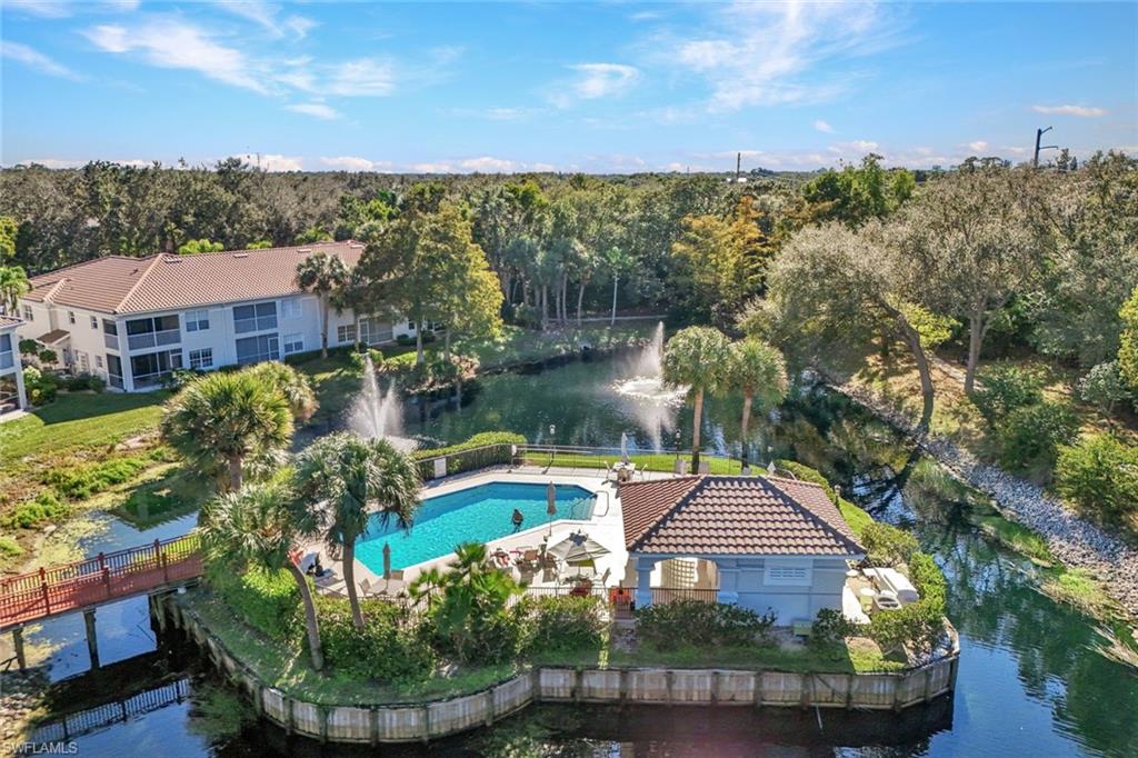 6883 Redbay Park Road, Unit 102 Naples, FL 34109 - Photo 20 of 22 a view of a houses with a yard