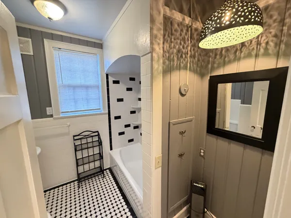 a bathroom with a toilet a sink and a window