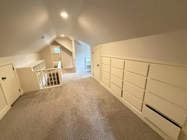 a view of staircase with white walls and railing