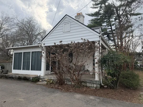 an empty room with wooden floor and fireplace