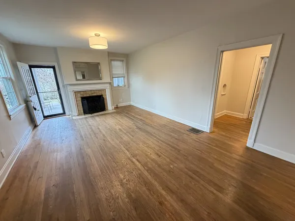 an empty room with furniture and a window