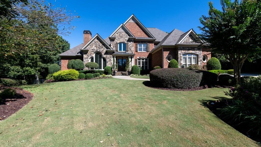 165 Autry Trail Alpharetta, GA 30022 - Photo 3 of 70 a front view of a house with a yard and garage