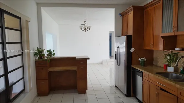 a kitchen with a refrigerator and cabinets