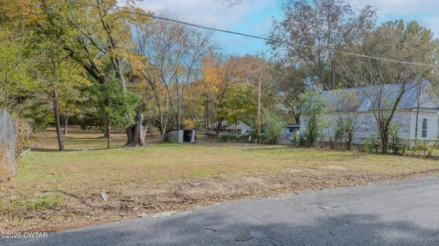 a backyard of a house with large trees