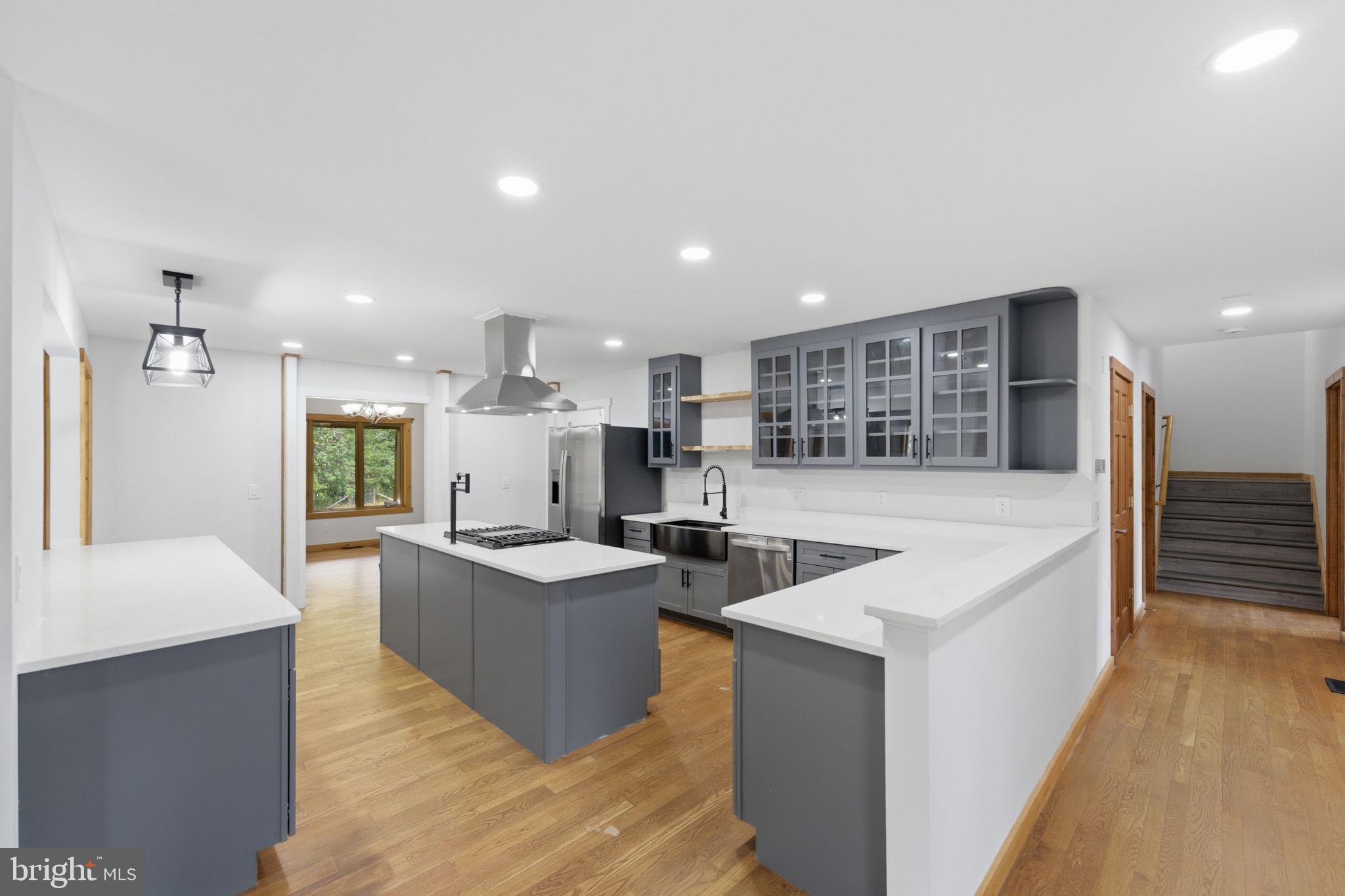 7522 Stubbs Bridge Road Spotsylvania, VA 22551 - Photo 15 of 60 a large living room with stainless steel appliances kitchen island a stove a table and chairs