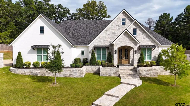 a front view of a house with a yard table and chairs